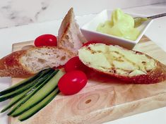 bread, cheese and vegetables on a cutting board with a bowl of mayonnaise