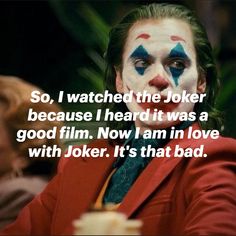 a man with his face painted like the joker is looking at something in front of him