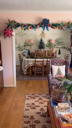 the living room is decorated for christmas with decorations on the wall and in the dining area