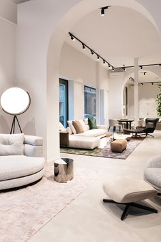 a living room filled with lots of white furniture