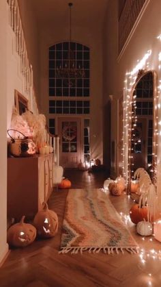 a hallway decorated for halloween with pumpkins and lights