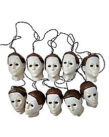 a group of white masks with brown hair on top of each one and string attached to them