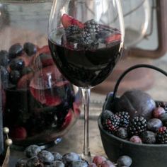 black and white photograph of wine, fruit and kettles