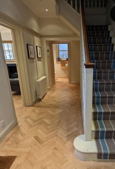 the stairs in this house are made of wood and have been painted blue with white stripes