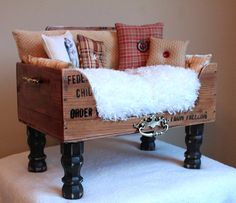 a couch made out of an old crate and some pillows on top of the chair