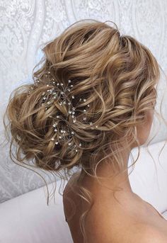 a woman with blonde hair wearing a wedding hairstyle