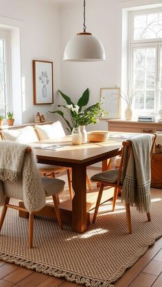 a dining room table and chairs with blankets on them