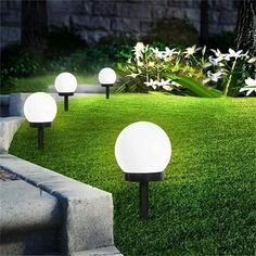 several white lights sitting on top of green grass