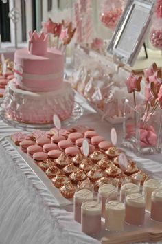 a table topped with lots of cakes and desserts