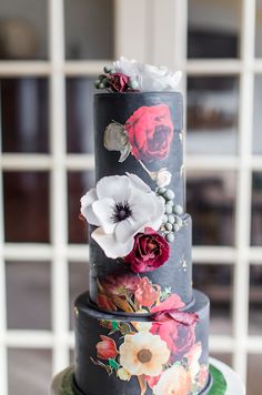 a three tiered cake with flowers on it