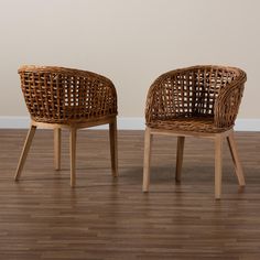 two wicker chairs sitting on top of a hard wood floor next to each other