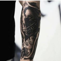 a person with a black and grey tattoo on their arm