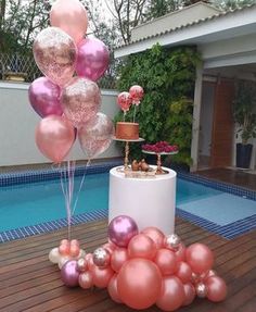 some pink and gold balloons near a pool