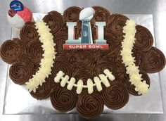 a football themed cake with chocolate frosting and white icing on the top that says i love super bowl