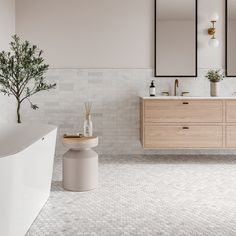 a bathroom with two sinks, mirrors and a bathtub