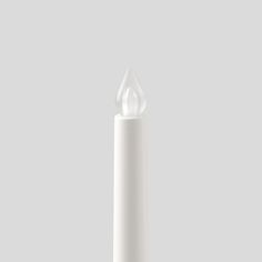 a white candle is on a gray background