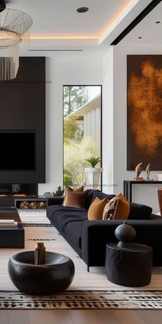 a modern living room with black furniture and art