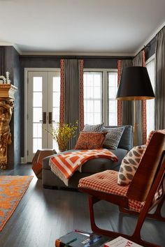 a living room filled with furniture and a fire place next to a window covered in curtains