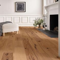 a living room with hardwood floors and white walls