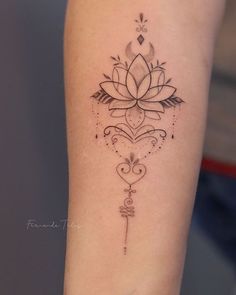 a woman's arm with a lotus tattoo on it