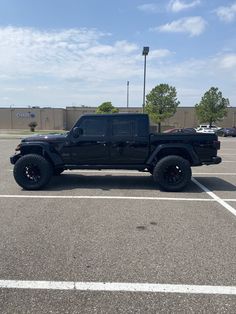 a black jeep parked in a parking lot