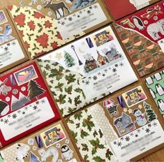 several christmas cards are laid out on a table with paper cut outs and stickers