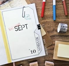 several different types of rubber stamps on a wooden table with scissors and other crafting supplies