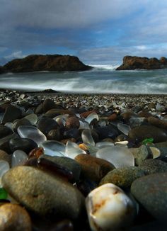 rocks and pebbles on the beach with waves coming in