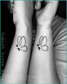 two people with matching tattoos on their arms