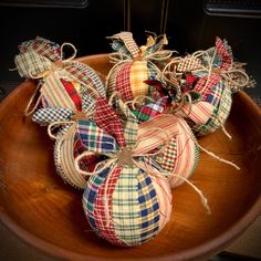 plaid fabric wrapped pumpkins in a wooden bowl