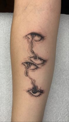 a woman's leg with a black and white tattoo design on the left calf