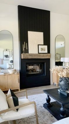 a living room filled with furniture and a fire place next to a wall mounted mirror