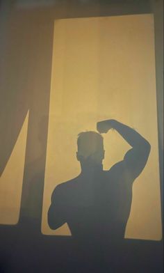 the shadow of a man standing in front of a window