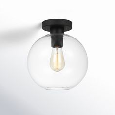 a light that is on the wall with a glass ball hanging from it's side