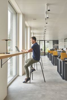 a man sitting at a desk using a laptop computer