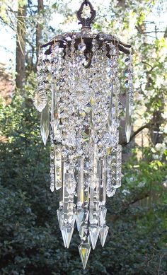 a crystal chandelier hanging in front of trees