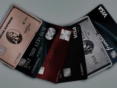 four credit cards stacked on top of each other