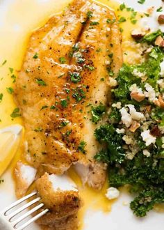 a white plate topped with chicken, broccoli and feta cheese