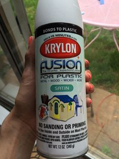 a person holding up a can of krylon dust on the window sill