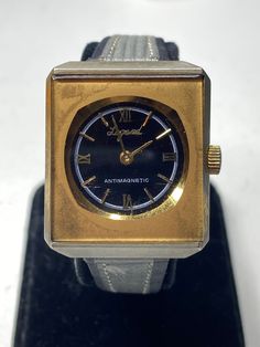 Here's a really cool Legend ladies watch. The watch works great and keeps good time. The strap is made from leather and good quality. The watch has a very cool square face which is hard to find. The strap is designed for a smaller wrist  Please message me with any questions Retro Gold Rectangular Watches, Retro Gold Watches With Subdials, Gold Retro Watches With Subdials, Vintage Rectangular Watch With Metal Dial, Vintage Gold Square Watch, Gold Retro Watch With Polished Finish, Vintage Cuff Watch With Leather Strap, Vintage Yellow Gold Self-winding Watch Accessories, Kids Rings