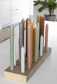 a set of seven candles sitting on top of a wooden stand