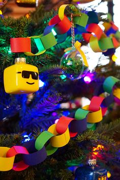 a christmas tree decorated with legos and ornaments in the shape of people's faces