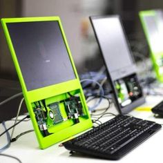 three computers sitting on top of a white table