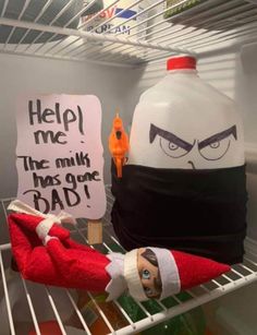 an elf's head is sitting on top of a shelf next to a bottle of milk