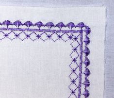 a close up of a piece of cloth with stitching on the edges and an embroidered border