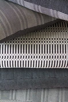 four different types of fabrics stacked on top of each other in rows, all with black and white patterns