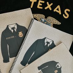 three notebooks with pictures of men's clothing and the words texas on them