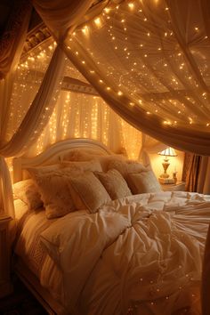 a bed covered in white sheets and lights