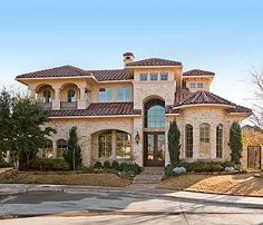 a large house with lots of windows and landscaping