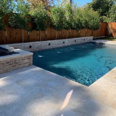 a backyard with a pool and hot tub